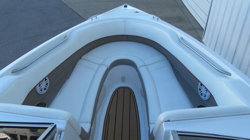 Slide: The Image of Bow seating area of a 2006 Cobalt 250 boat with white and gray upholstery. - 10