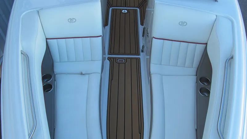 Slide: The Image of 2006 Cobalt 250 boat interior with white seating and wood accents. - 11