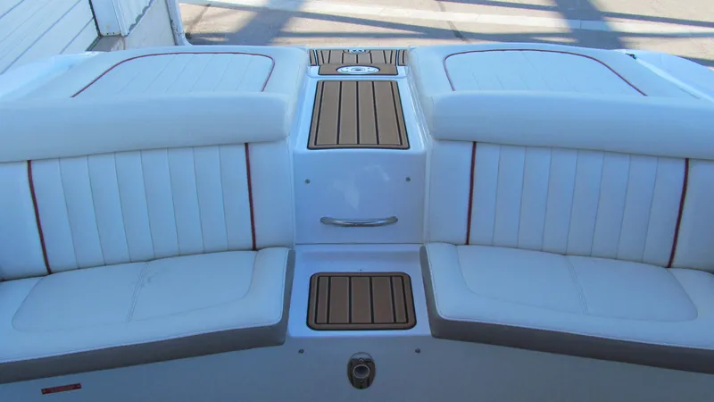 Slide: The Image of 2006 Cobalt 250 boat interior with white cushioned seating and wood accents. - 14