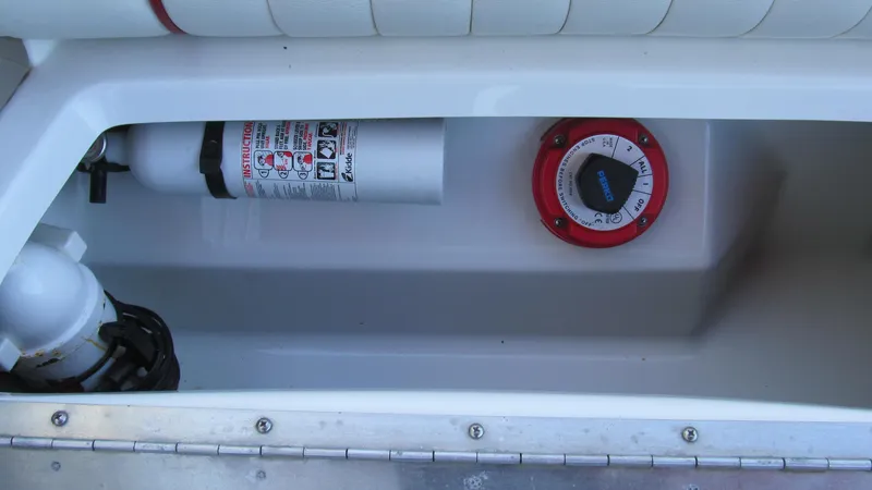 Slide: The Image of 2006 Cobalt 250 boat compartment with fire extinguisher and control dial. - 15