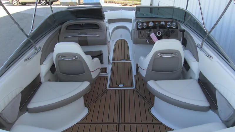 Slide: The Image of Interior of a 2006 Cobalt 250 boat with sleek seating and wood-style flooring. - 5