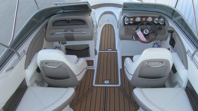 Slide: The Image of Interior of a 2006 Cobalt 250 boat with sleek seating and wood accents. - 6