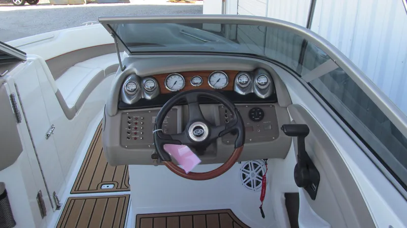 Slide: The Image of 2006 Cobalt 250 boat dashboard with steering wheel and gauges. - 7