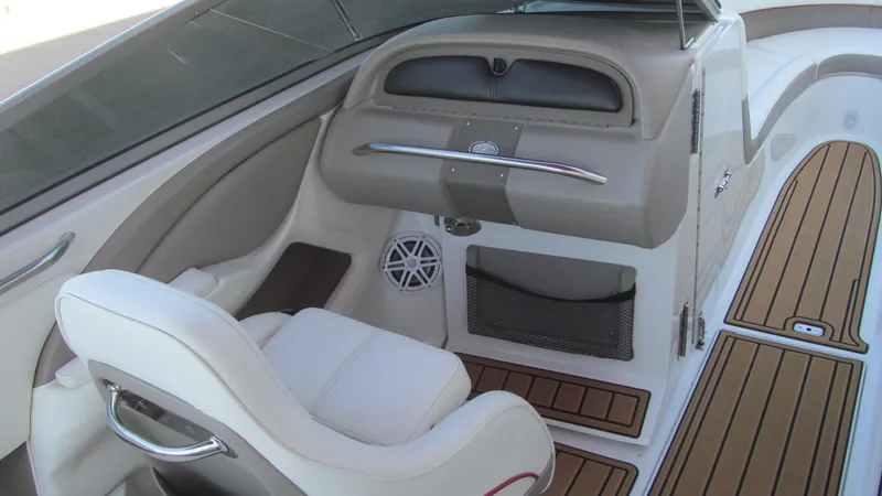 Slide: The Image of Interior of a 2006 Cobalt 250 boat with white seating and wood accents. - 8