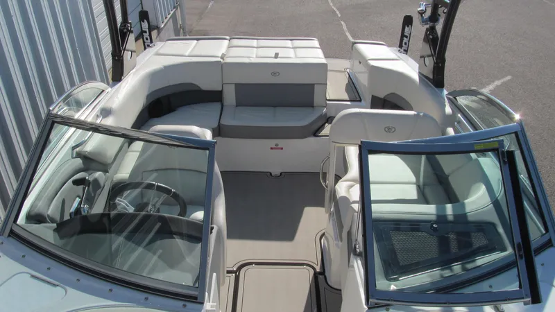 Slide: The Image of 2018 Cobalt 220S boat interior with seating and steering wheel. - 10