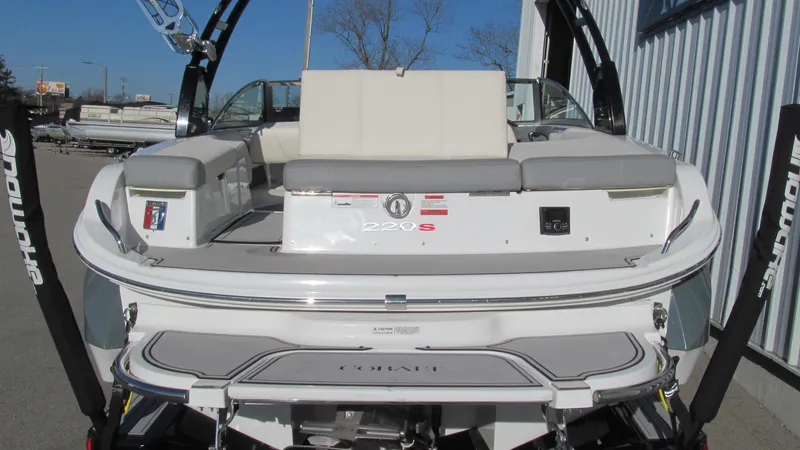Slide: The Image of 2018 Cobalt 220S boat, rear view, white exterior, docked outdoors. - 13