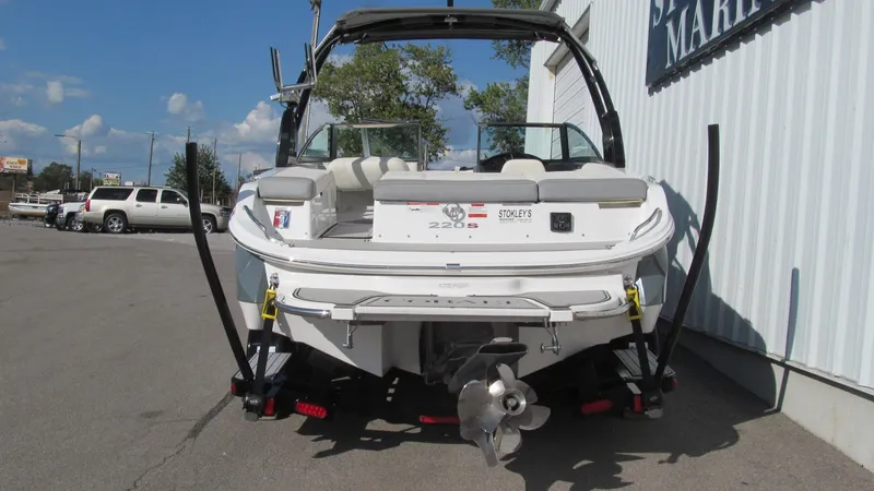 Slide: The Image of 2018 Cobalt 220S boat parked outside a marina, rear view. - 3