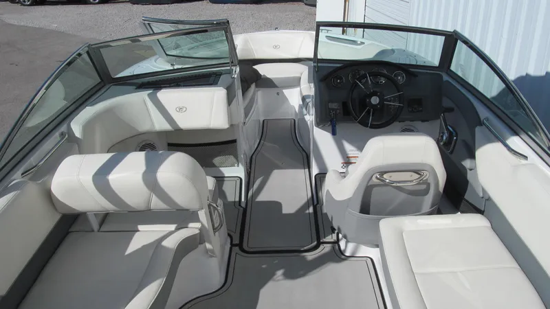 Slide: The Image of 2018 Cobalt 220S boat interior with white seating and steering console. - 4