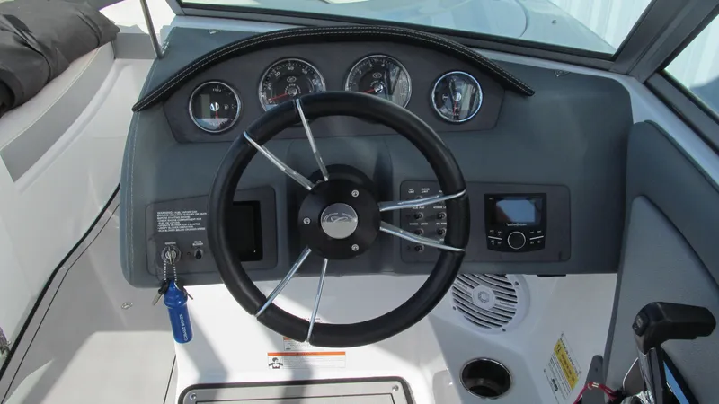 Slide: The Image of 2018 Cobalt 220S boat dashboard with steering wheel and gauges. - 5