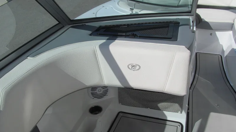 Slide: The Image of 2018 Cobalt 220S boat interior with white seating and speaker detail. - 6