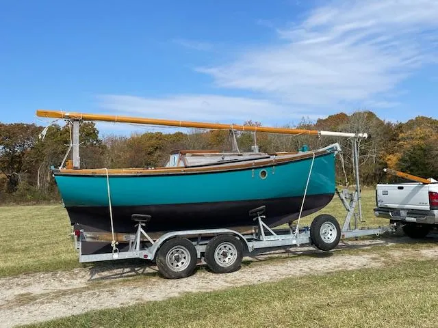 The Image of 2009 Golant Gaffer Cutter Rig sailboat on trailer, parked in grassy area. - 0