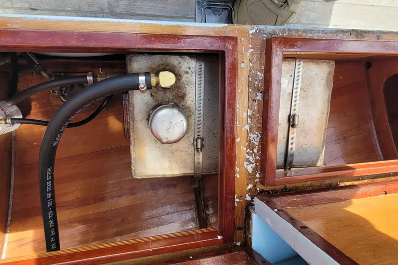 Slide: The Image of Interior view of a 2009 Golant Gaffer Cutter Rig showing fuel tank and wooden compartments. - 26