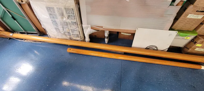 Slide: The Image of Wooden mast and boom of a 2009 Golant Gaffer Cutter Rig on blue floor. - 31