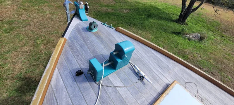 Slide: The Image of Golant Gaffer Cutter Rig 2009 deck with equipment, set on grassy landscape. - 32