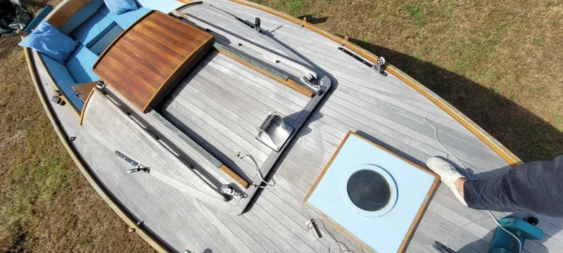Slide: The Image of Golant Gaffer Cutter Rig 2009 boat deck with wooden and blue accents, viewed from above. - 33