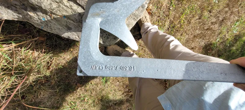 Slide: The Image of Person holding a metal anchor outdoors, Golant Gaffer Cutter Rig, 2009. - 44