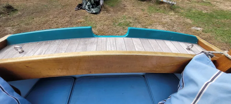 Slide: The Image of Golant Gaffer Cutter Rig 2009 boat interior with wooden and blue seating, outdoor setting. - 8