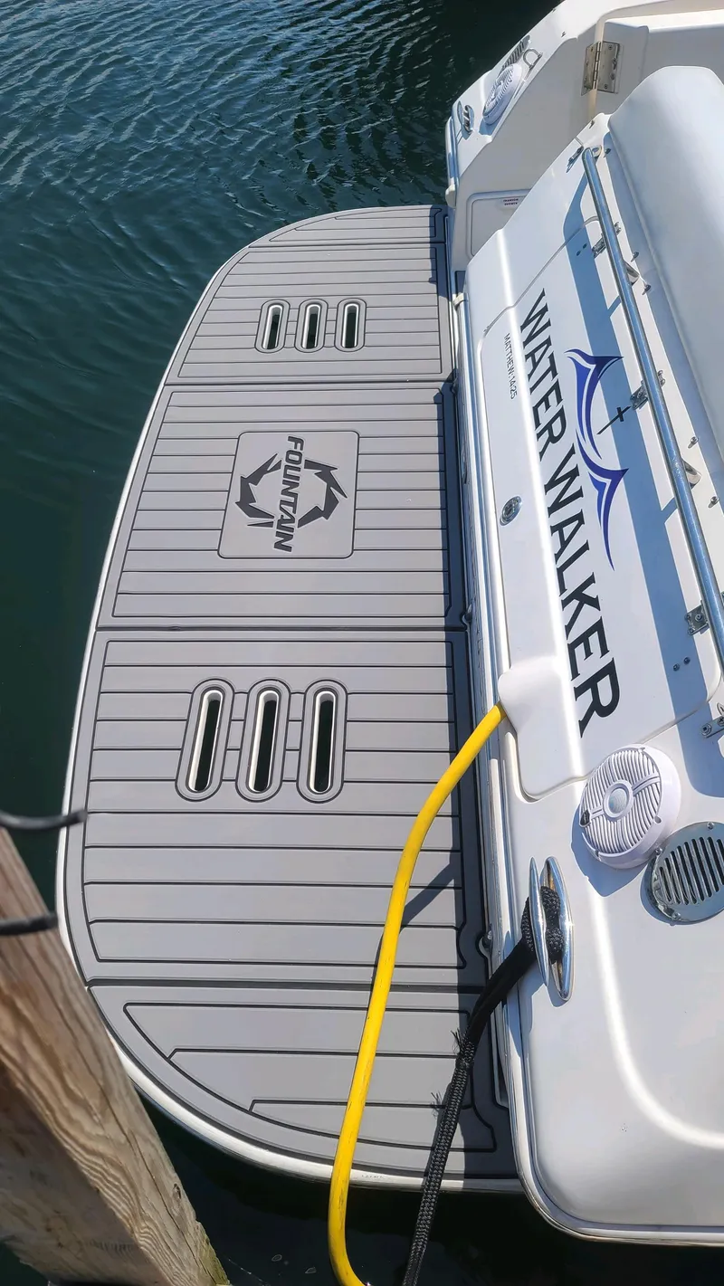 Slide: The Image of 2006 Fountain 48 Express Cruiser boat docked with swim platform and "Water Walker" branding. - 11