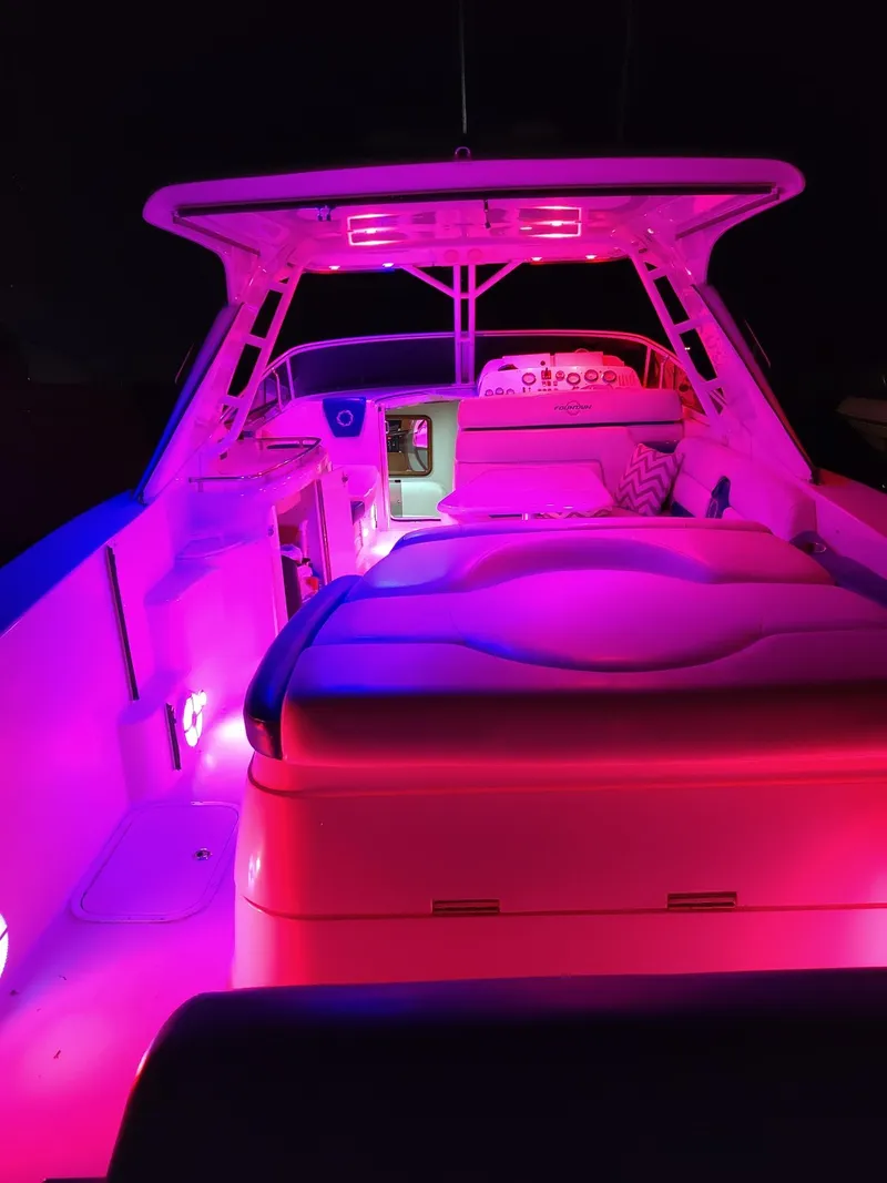 Slide: The Image of 2006 Fountain 48 Express Cruiser with vibrant pink interior lighting at night. - 16