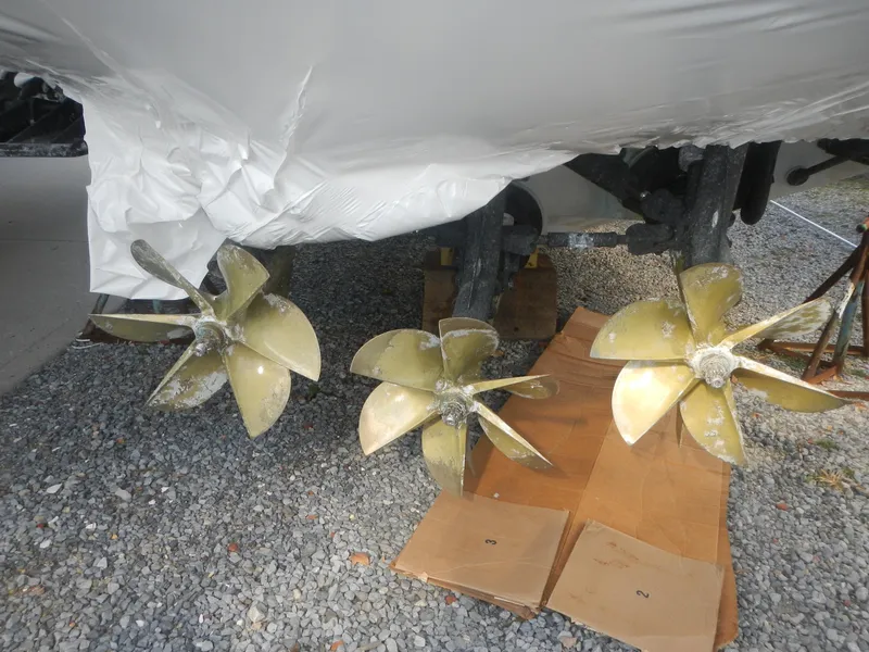Slide: The Image of 2006 Fountain 48 Express Cruiser propellers on gravel surface. - 4