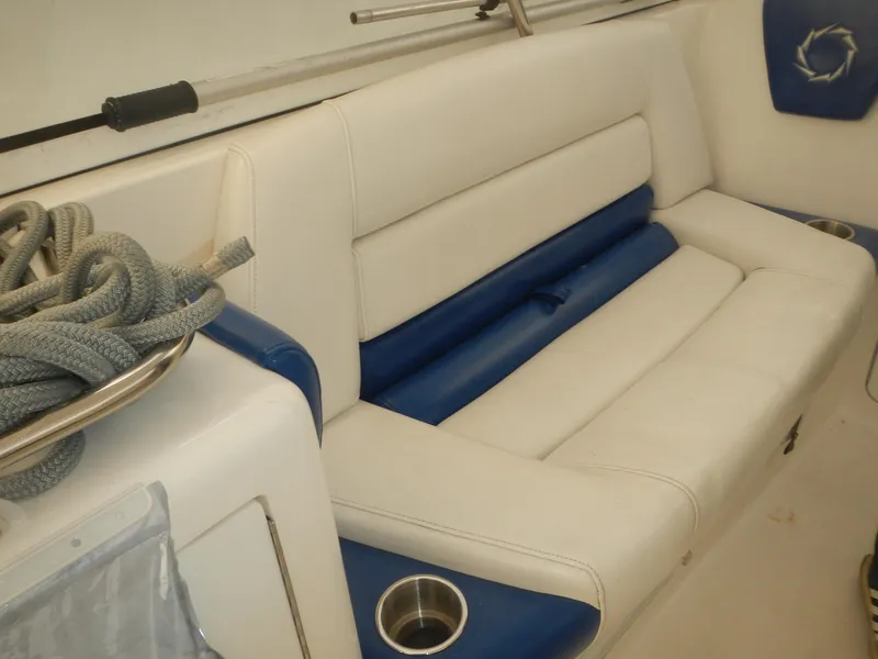 Slide: The Image of 2006 Fountain 48 Express Cruiser interior with white and blue seating, cup holder, and rope. - 5