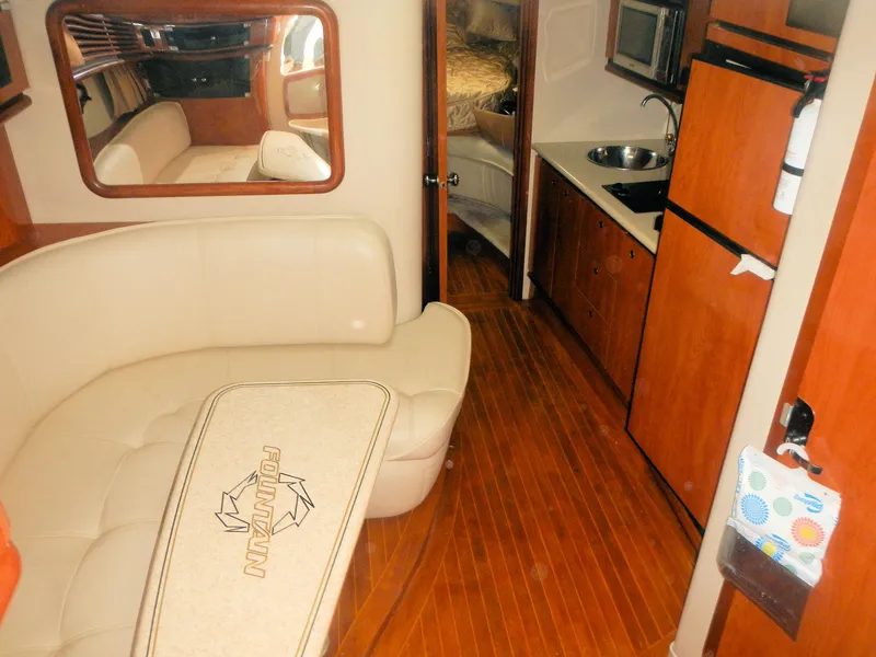 Slide: The Image of Interior of 2006 Fountain 48 Express Cruiser with kitchen and seating area. - 7