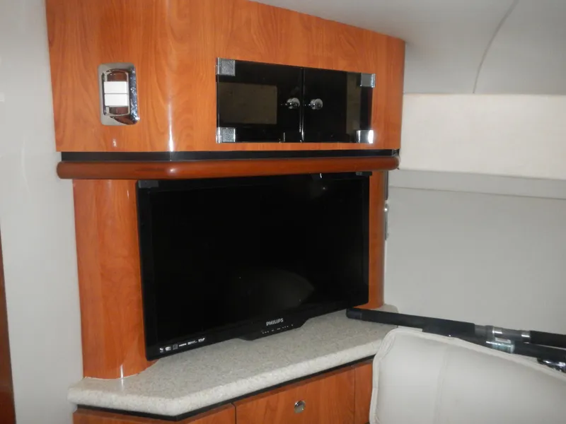 Slide: The Image of Interior of 2006 Fountain 48 Express Cruiser with TV and wooden cabinetry. - 9