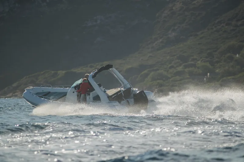 Slide: The Image of 2025 Zodiac Medline 7.5 speeding on water near rocky coastline. - 19