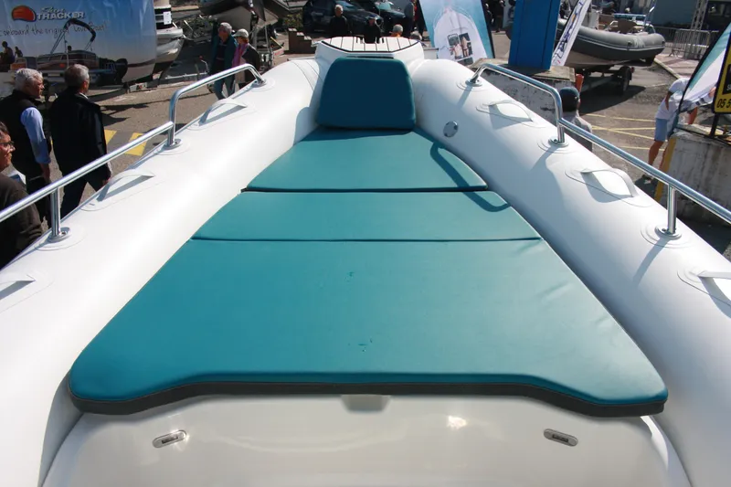 Slide: The Image of 2025 Zodiac Medline 7.5 boat with teal sunbathing deck, showcased outdoors. - 10