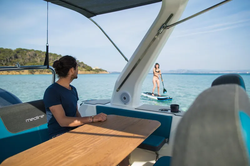 Slide: The Image of Man on Zodiac Medline 7.5 boat watching paddleboarder on calm sea, 2025 model. - 15