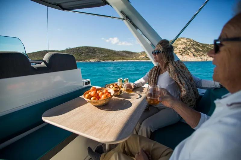 Slide: The Image of Couple enjoying drinks on Zodiac Medline 7.5 boat, 2025 model, with scenic ocean view. - 18