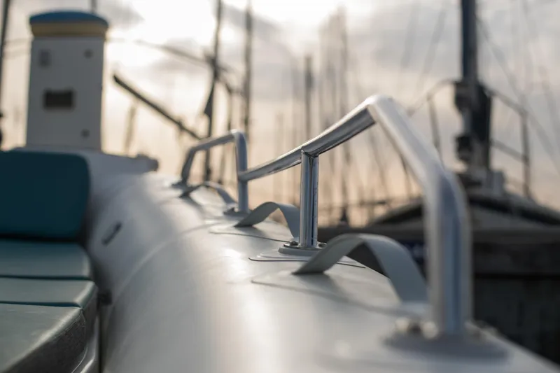 Slide: The Image of 2025 Zodiac Medline 7.5 boat detail with metal railings in a marina setting. - 21