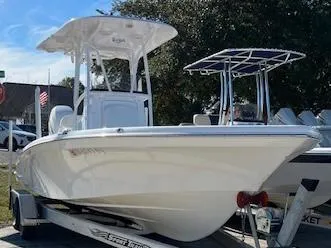 Slide: The Image of 2018 BlackJack 256 Bay boat on trailer, white hull, outdoor display. - 1