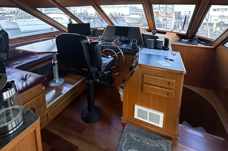 Slide: The Image of Interior of 1990 Tollycraft 57 wide body yacht with helm and seating area. - 10