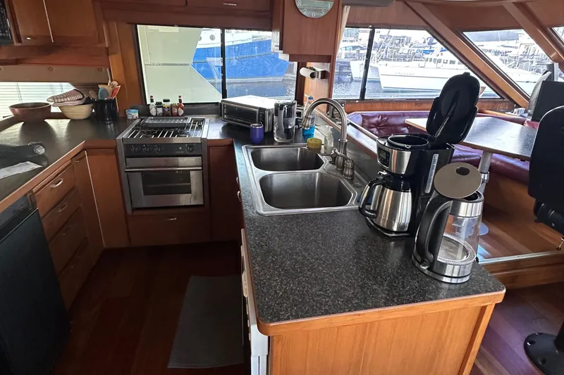 Slide: The Image of 1990 Tollycraft 57 wide body yacht kitchen with modern appliances and spacious countertops. - 11