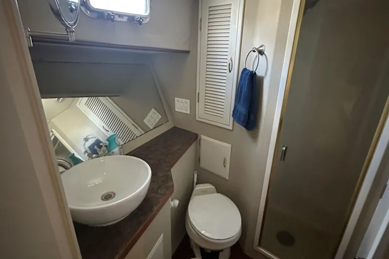Slide: The Image of Bathroom interior of 1990 Tollycraft 57 Wide Body yacht with sink, toilet, and shower. - 14