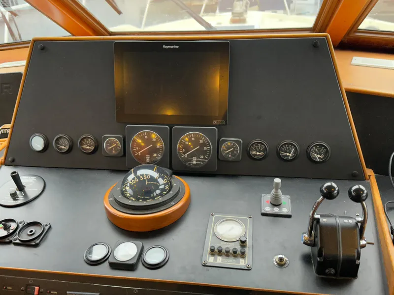 Slide: The Image of 1990 Tollycraft 57 wide body helm with navigation instruments and controls. - 18