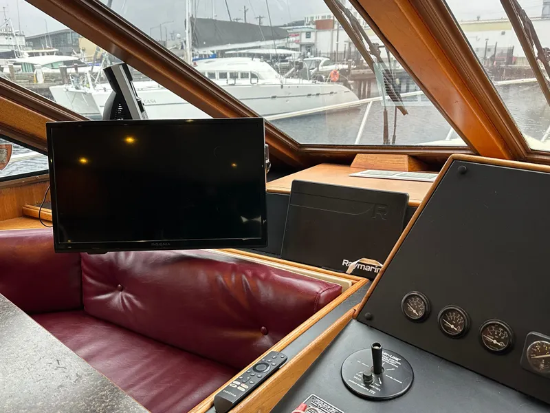 Slide: The Image of Interior of 1990 Tollycraft 57 wide body yacht with navigation equipment and leather seating. - 19