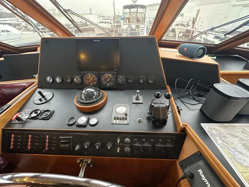Slide: The Image of 1990 Tollycraft 57 wide body yacht helm with navigation instruments and controls. - 20