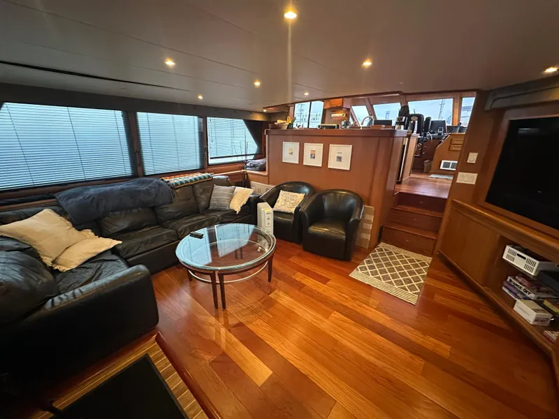 Slide: The Image of Luxurious interior of 1990 Tollycraft 57 wide body yacht with leather seating and wood flooring. - 22
