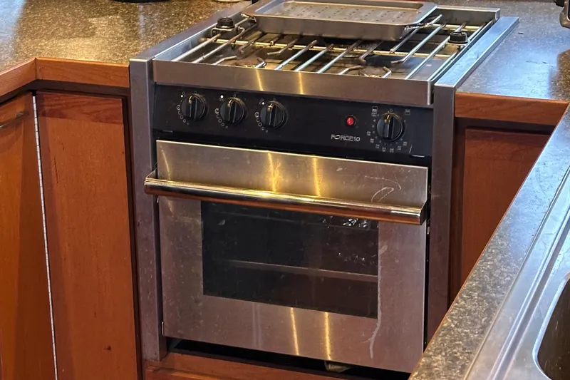 Slide: The Image of Stainless steel oven and stove in 1990 Tollycraft 57 wide body yacht kitchen. - 24