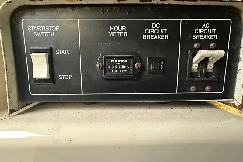 Slide: The Image of Control panel of a 1990 Tollycraft 57 wide body with hour meter and circuit breakers. - 26