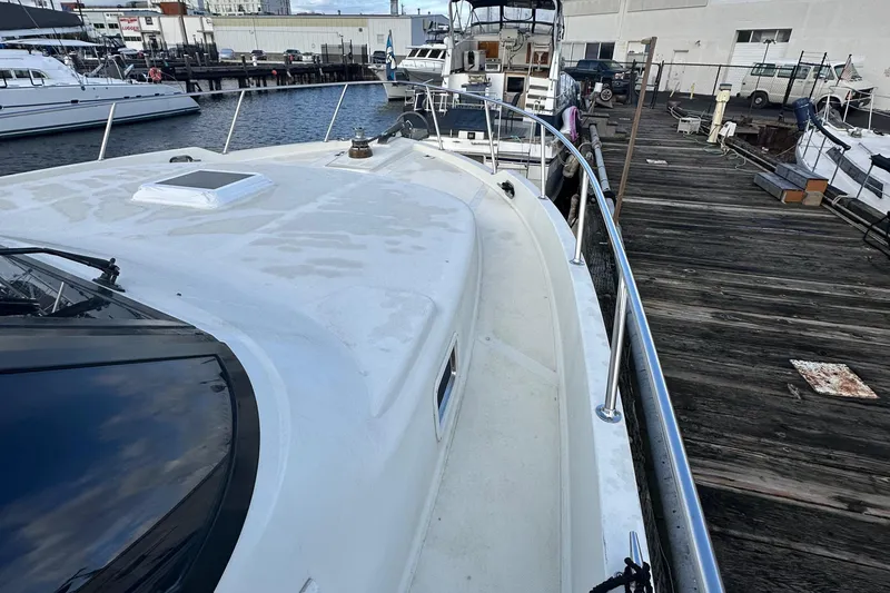 Slide: The Image of 1990 Tollycraft 57 wide body yacht docked at marina. - 4