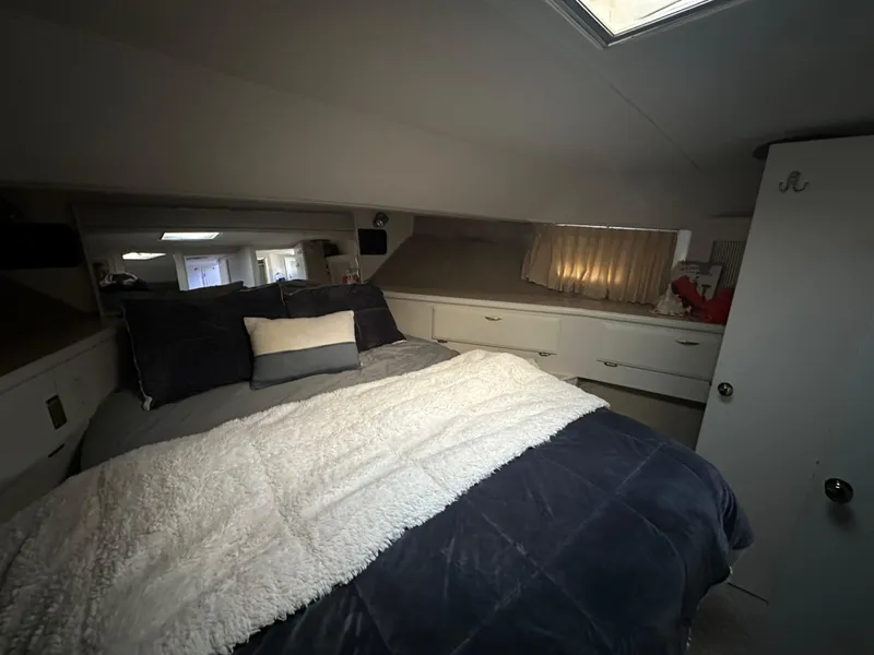 Slide: The Image of Cozy bedroom in 1990 Tollycraft 57 wide body yacht with plush bedding. - 8