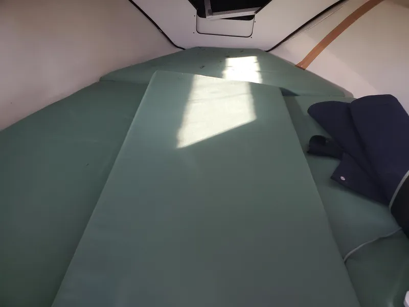 Slide: The Image of Interior cabin of 1986 Sport-Craft Sportfisher boat with green cushions. - 13