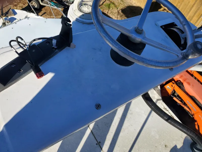 Slide: The Image of 1986 Sport-Craft Sportfisher boat helm with steering wheel and controls. - 19