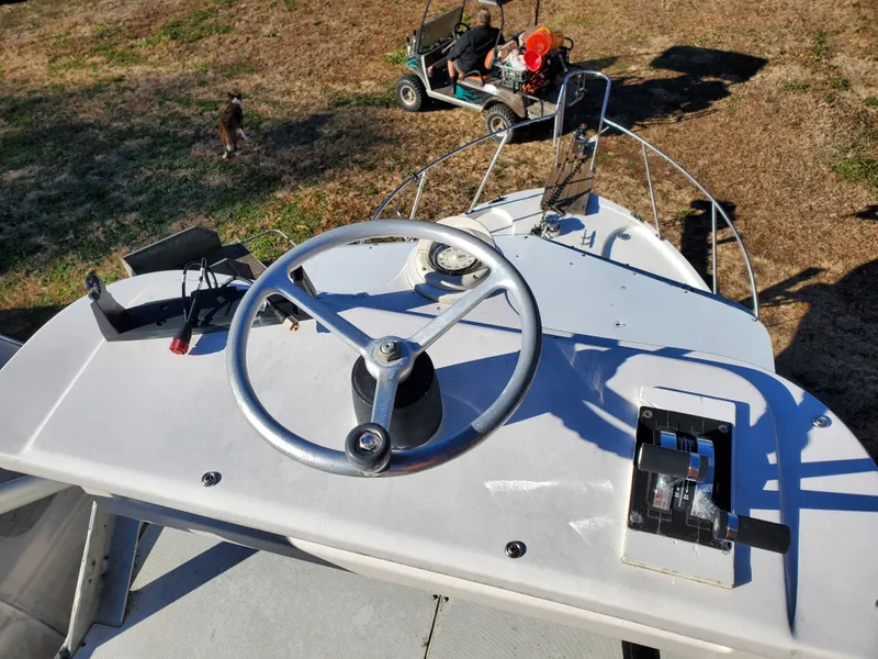 Slide: The Image of 1986 Sport-Craft Sportfisher boat helm with steering wheel and controls. - 21
