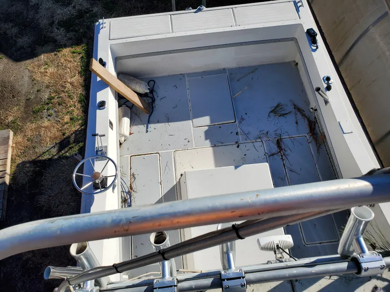 Slide: The Image of 1986 Sport-Craft Sportfisher boat deck, aerial view, showing steering wheel and fishing equipment. - 24