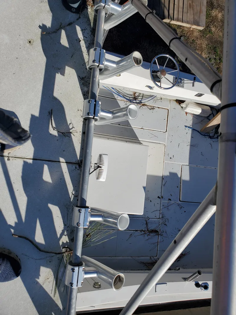 Slide: The Image of 1986 Sport-Craft Sportfisher boat deck with rod holders and steering wheel. - 26