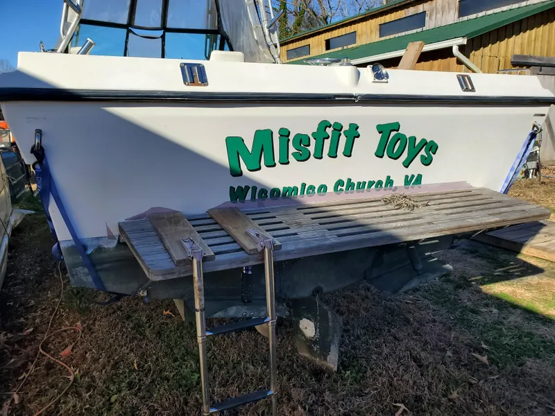 Slide: The Image of 1986 Sport-Craft Sportfisher boat named "Misfit Toys" in a yard setting. - 37